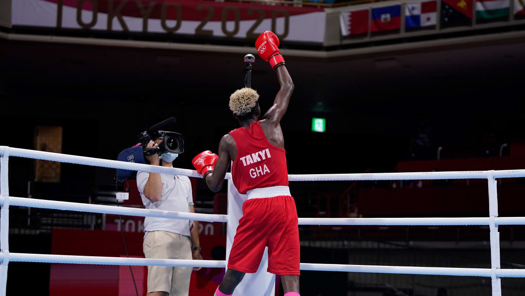 TOKYO, JAPAN - JULY 28: Samuel Takyi (red) of Ghana celebrates victory over Jean Carlos Caicedo Pachito of Ecuador during the Men's Feather (52-57kg) on day five of the Tokyo 2020 Olympic Games at Kokugikan Arena on July 28, 2021 in Tokyo, Japan. (Photo by Frank Franklin - Pool/Getty Images)