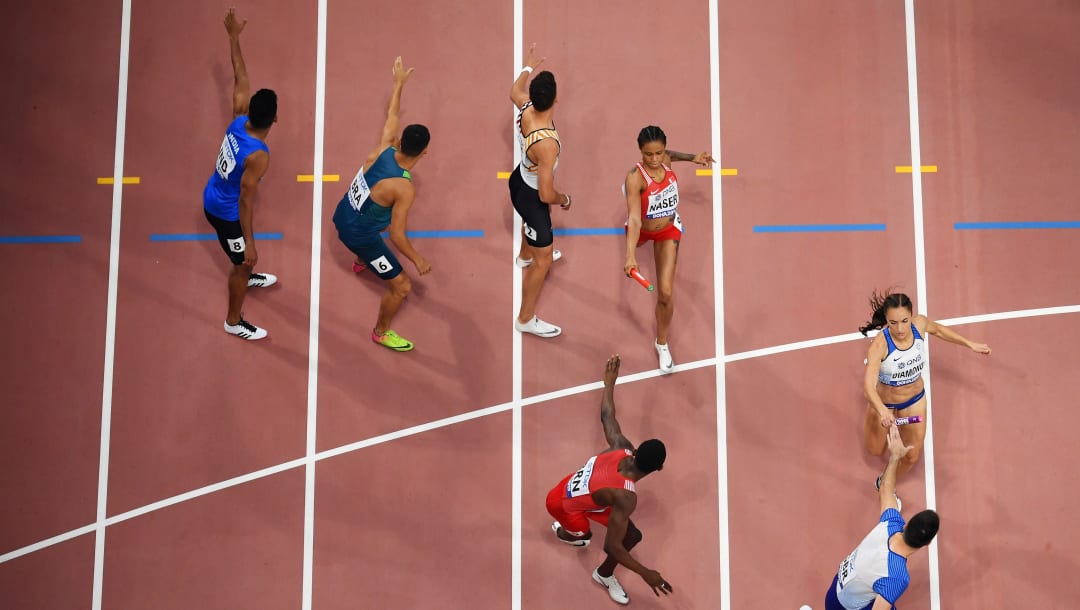 Martyn Rooney, de Gran Bretaña, recibe el testigo de Emily Diamond durante el relevo mixto de 4x400 m, en el Mundial de Doha 2019. (Imagen por Matthias Hangst/Getty Images)