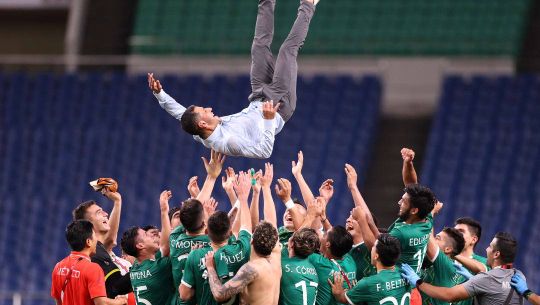 SAITAMA, JAPAN - AUGUST 06: Jaime Lozano, Head Coach of Mexico is thrown in the air by his players following victory in the Men's Bronze Medal Match between Mexico and Japan on day fourteen of the Tokyo 2020 Olympic Games at Saitama Stadium on August 06, 2021 in Saitama, Tokyo, Japan. (Photo by Leon Neal/Getty Images)