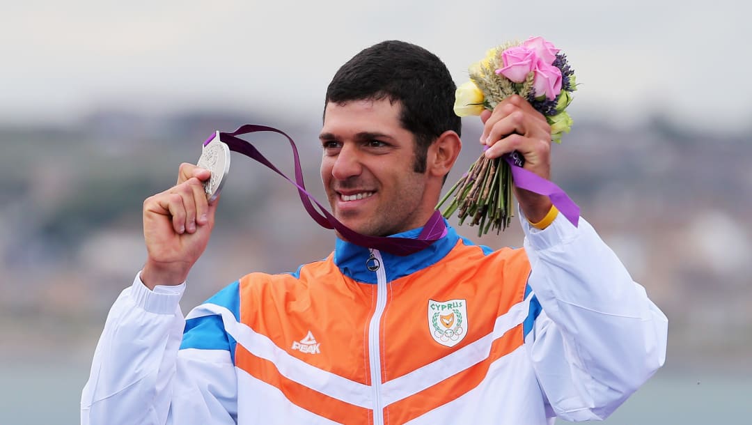 Pavlos Kontides of Cyprus poses with his silver medal from the Men's Laser Sailing at the Olympic Games London 2012 (Photo by Clive Mason/Getty Images)